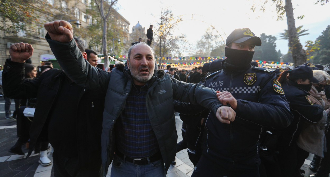 Сотрудник полиции задерживает активиста. Фото Азиза Каримова для "Кавказского узла"